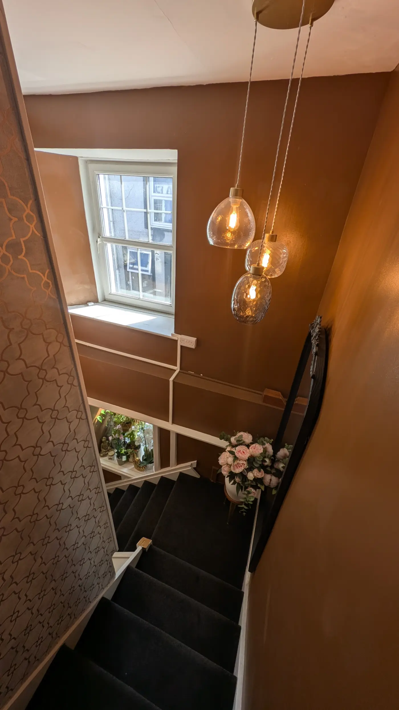The staircase up to the studio, with flowers on the landing