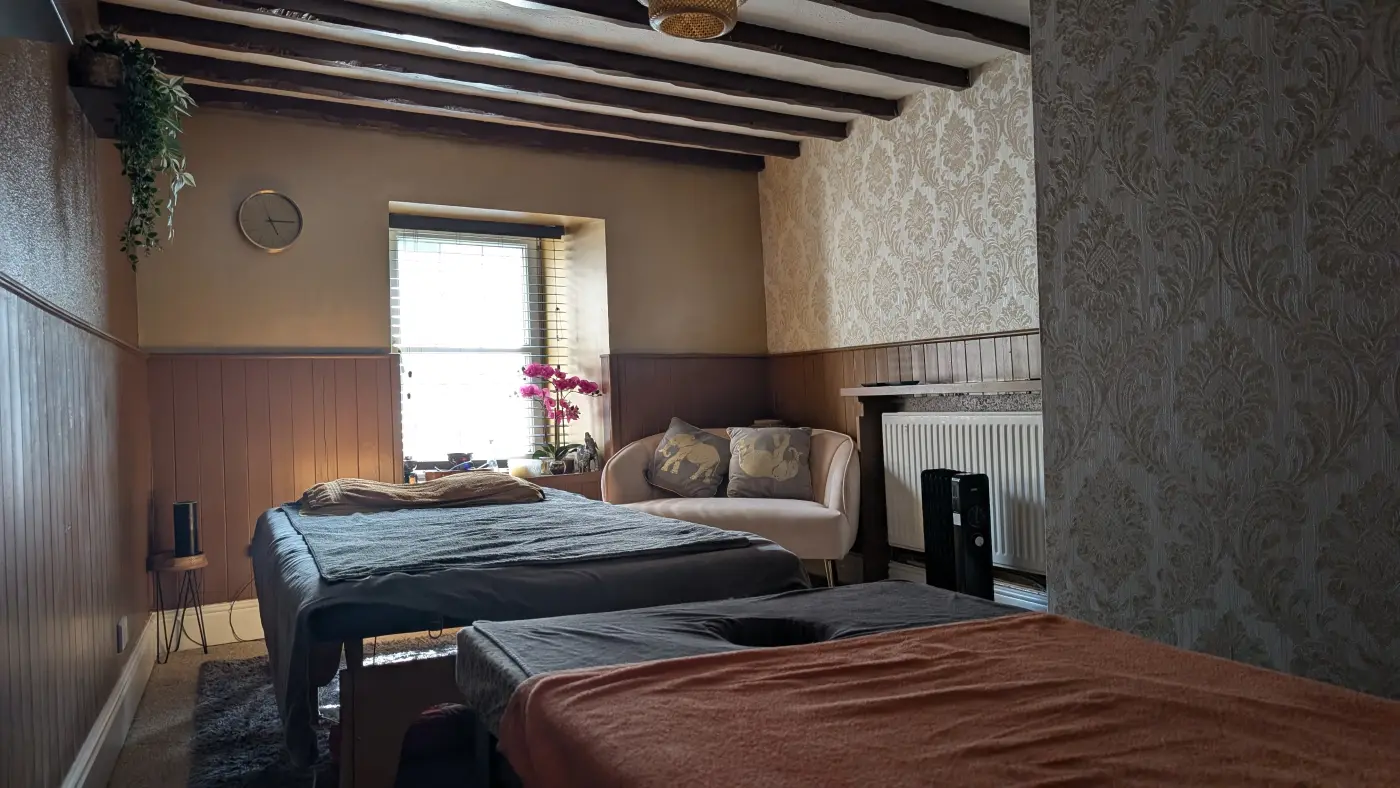 The treatment room under its exposed beams, looking towards the window